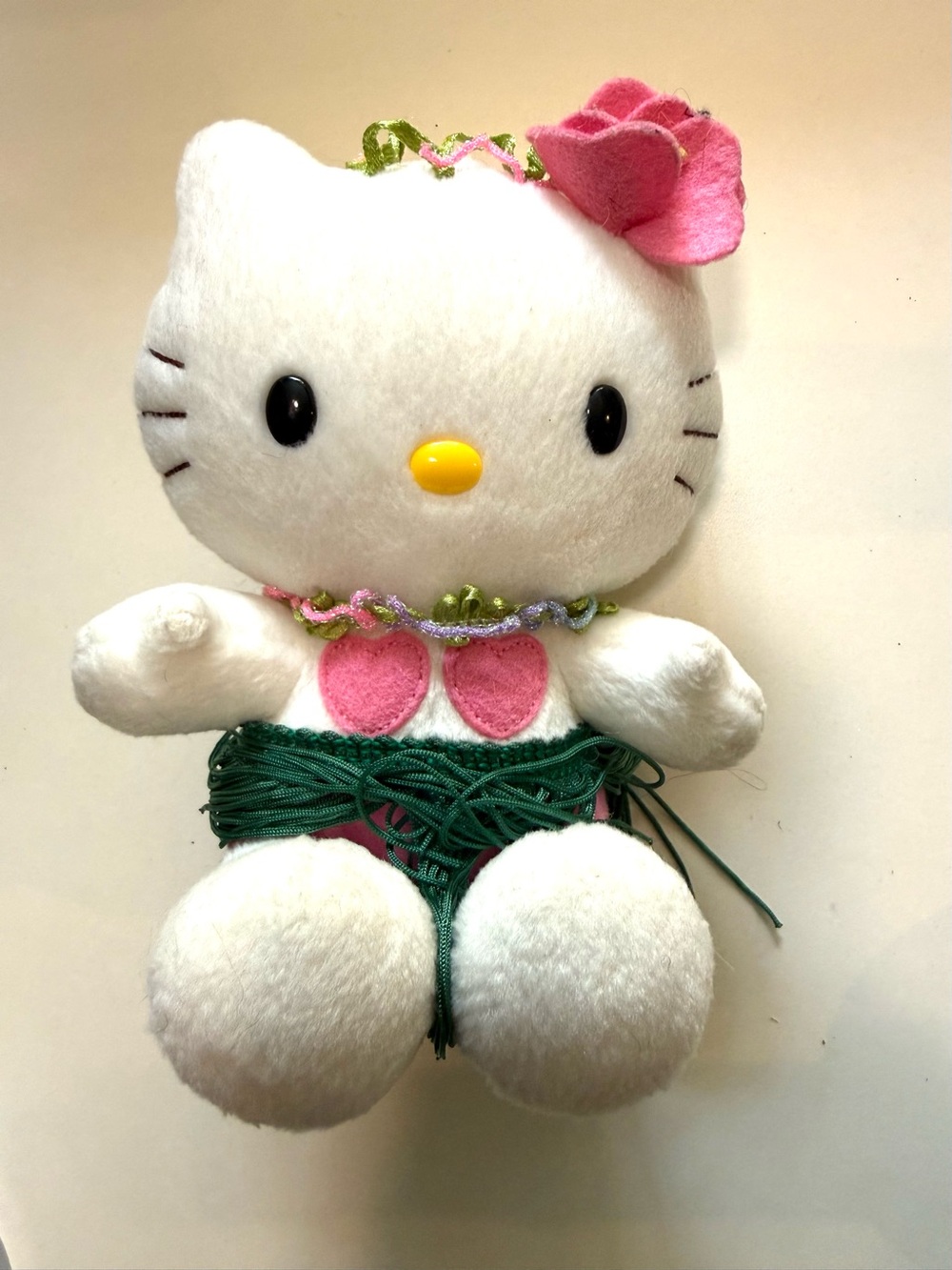 A vintage Sanrio Hello Kitty Hawaii Hula Skirt Plush from the early 2000s